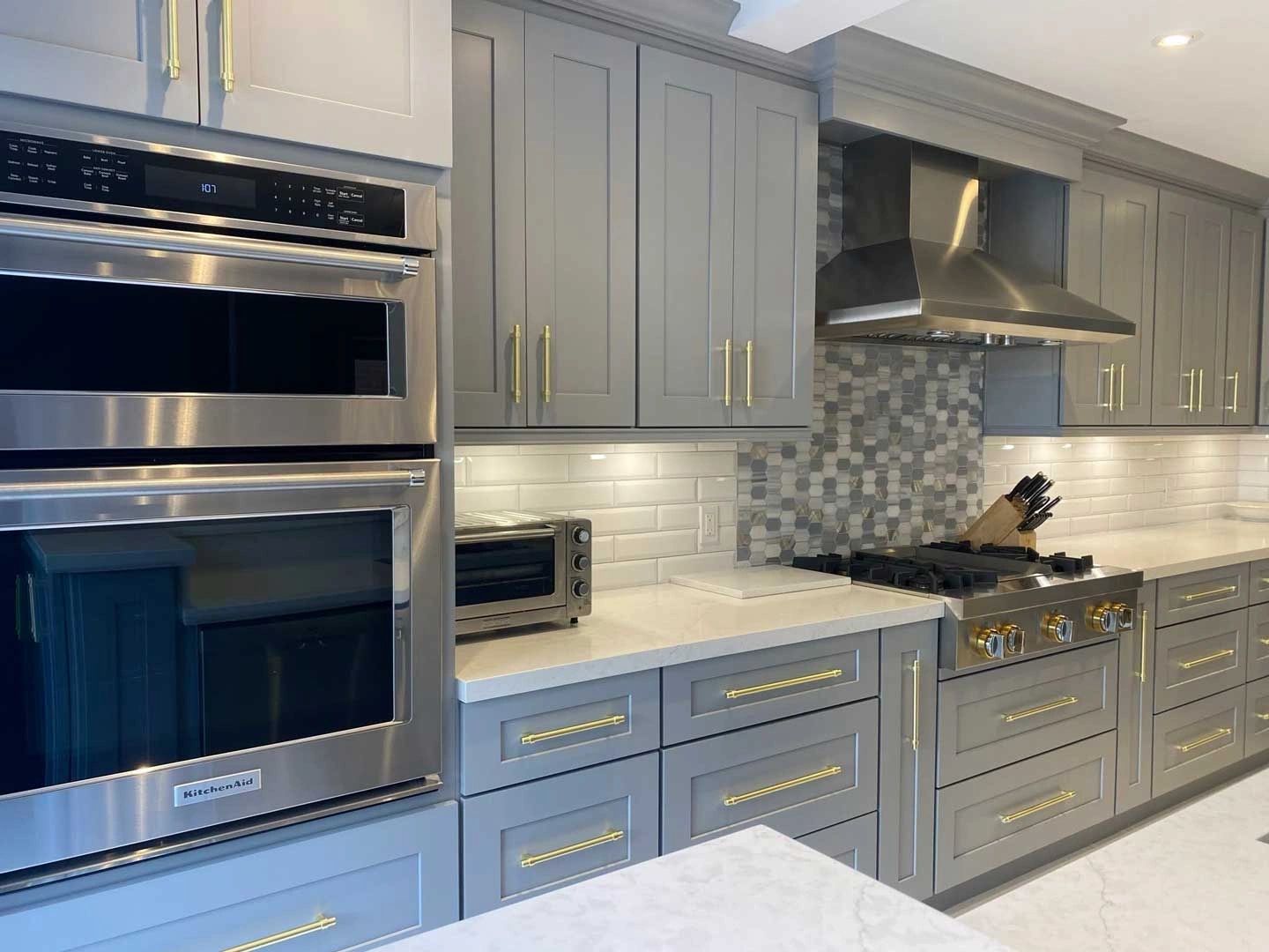 Gray shaker cabinetry with gold hardware shown by Viking